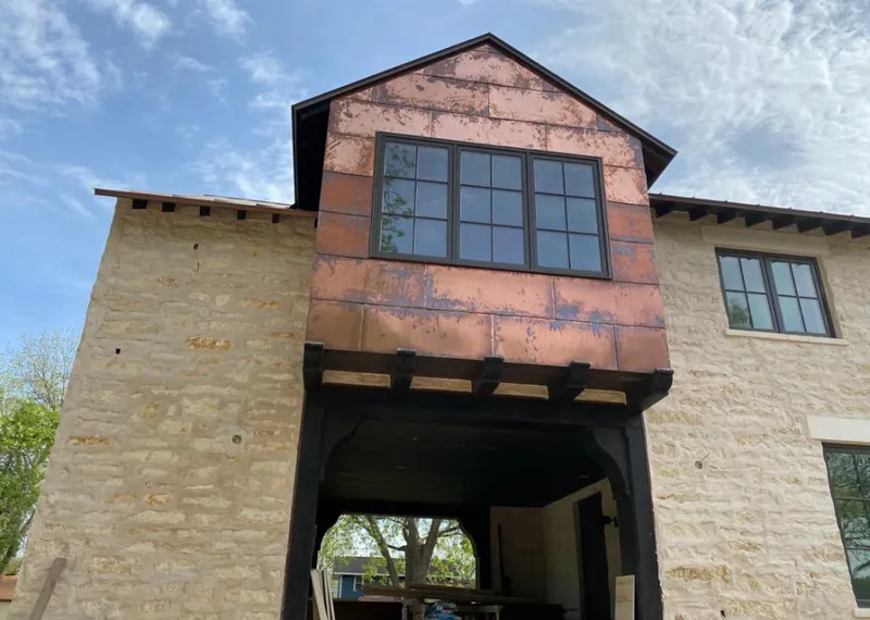 Copper metal panel facade on a stone building for Roof Repair in Harlingen